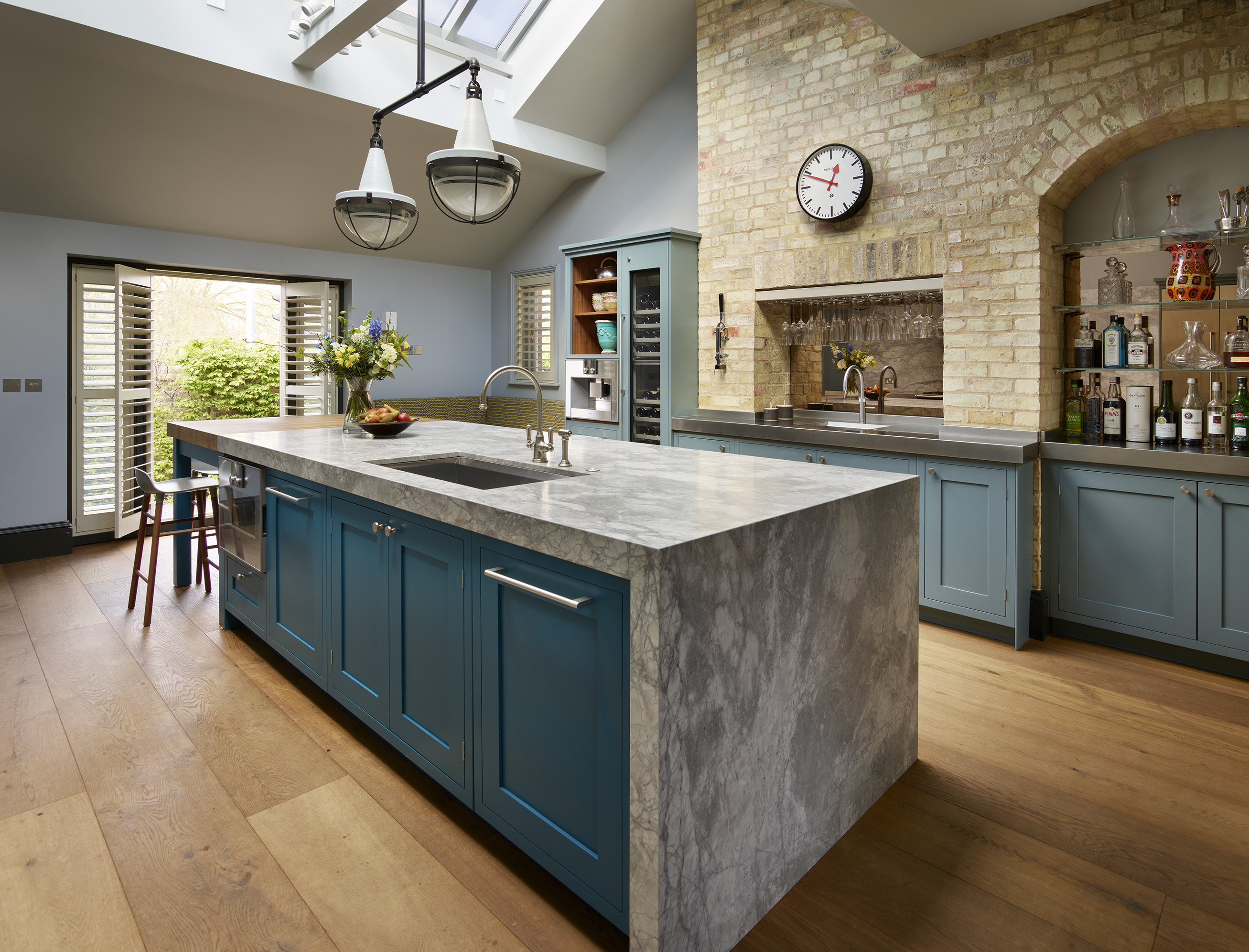 Handmade kitchens by Roundhouse with modern kitchen island and marble work surfaces