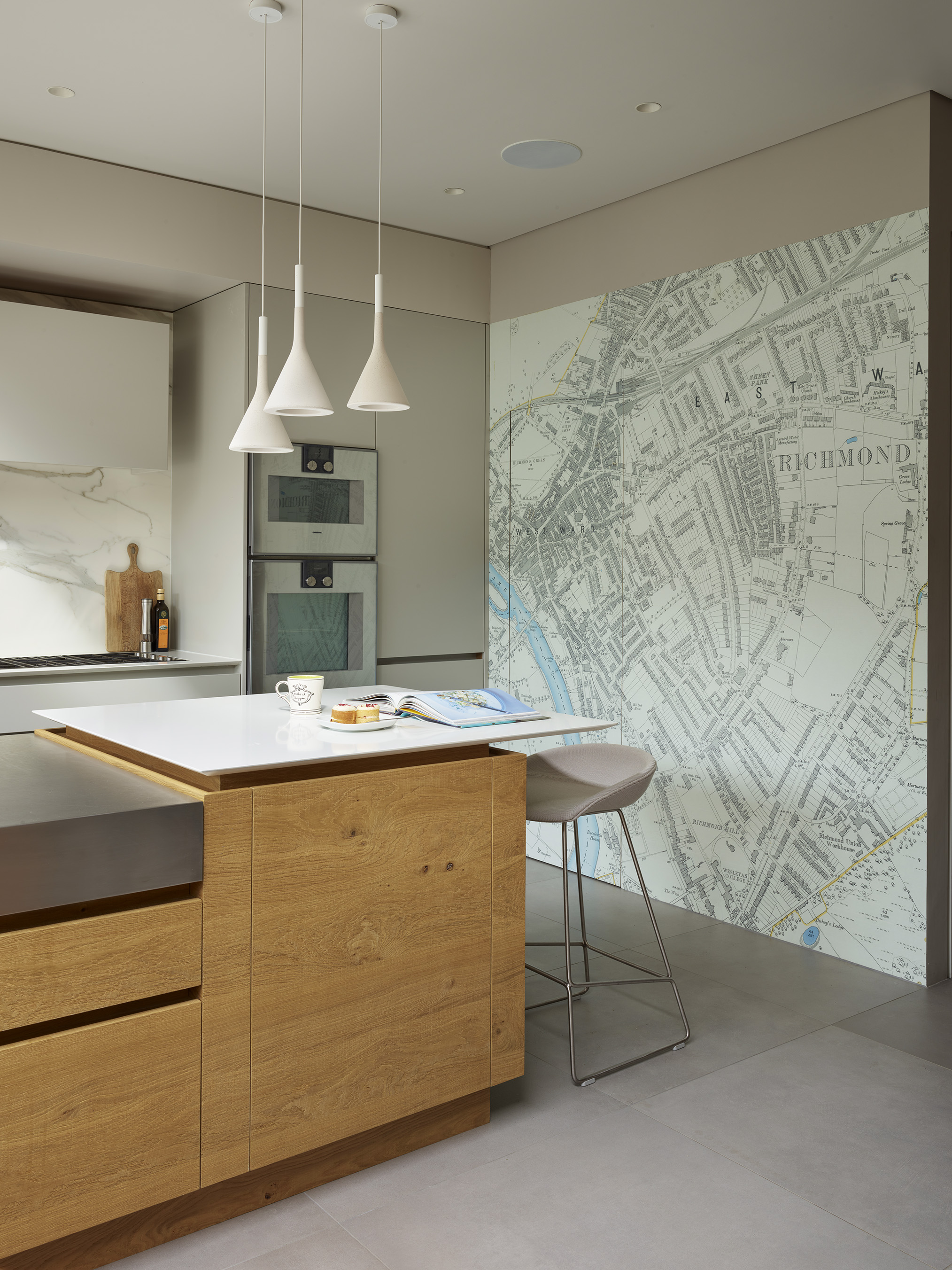 kitchen lighting pendant over a kitchen island with stainless steel and marble work surfaces