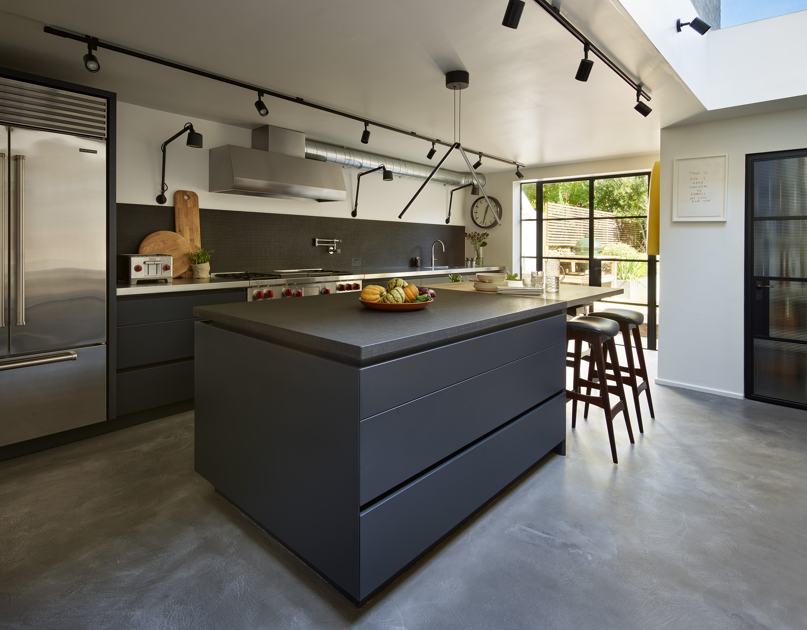 Modern kitchens with islands by Roundhouse with dark grey and stainless steel work surfaces