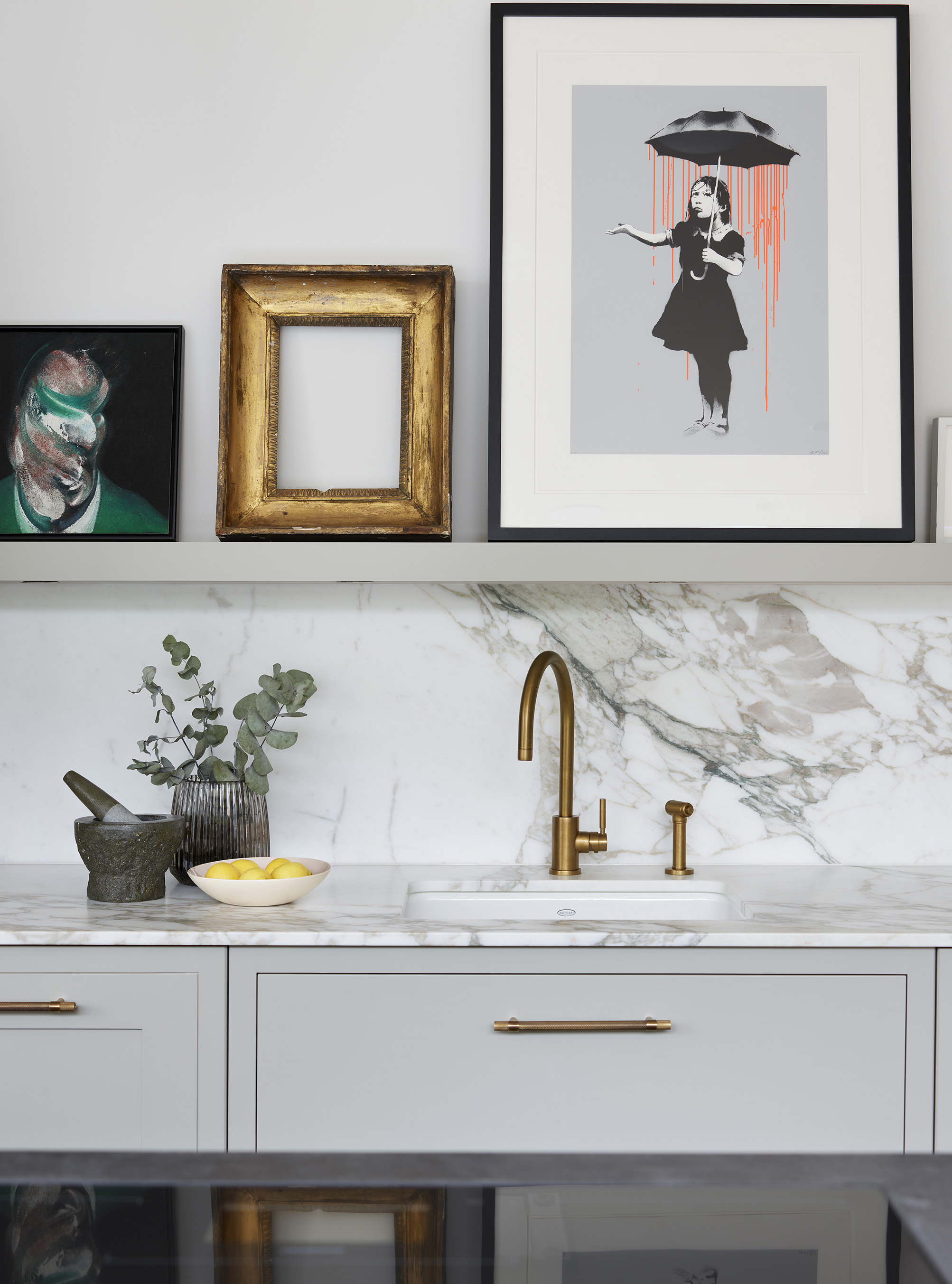 Modern luxury kitchen detail with brass handles and sink tap