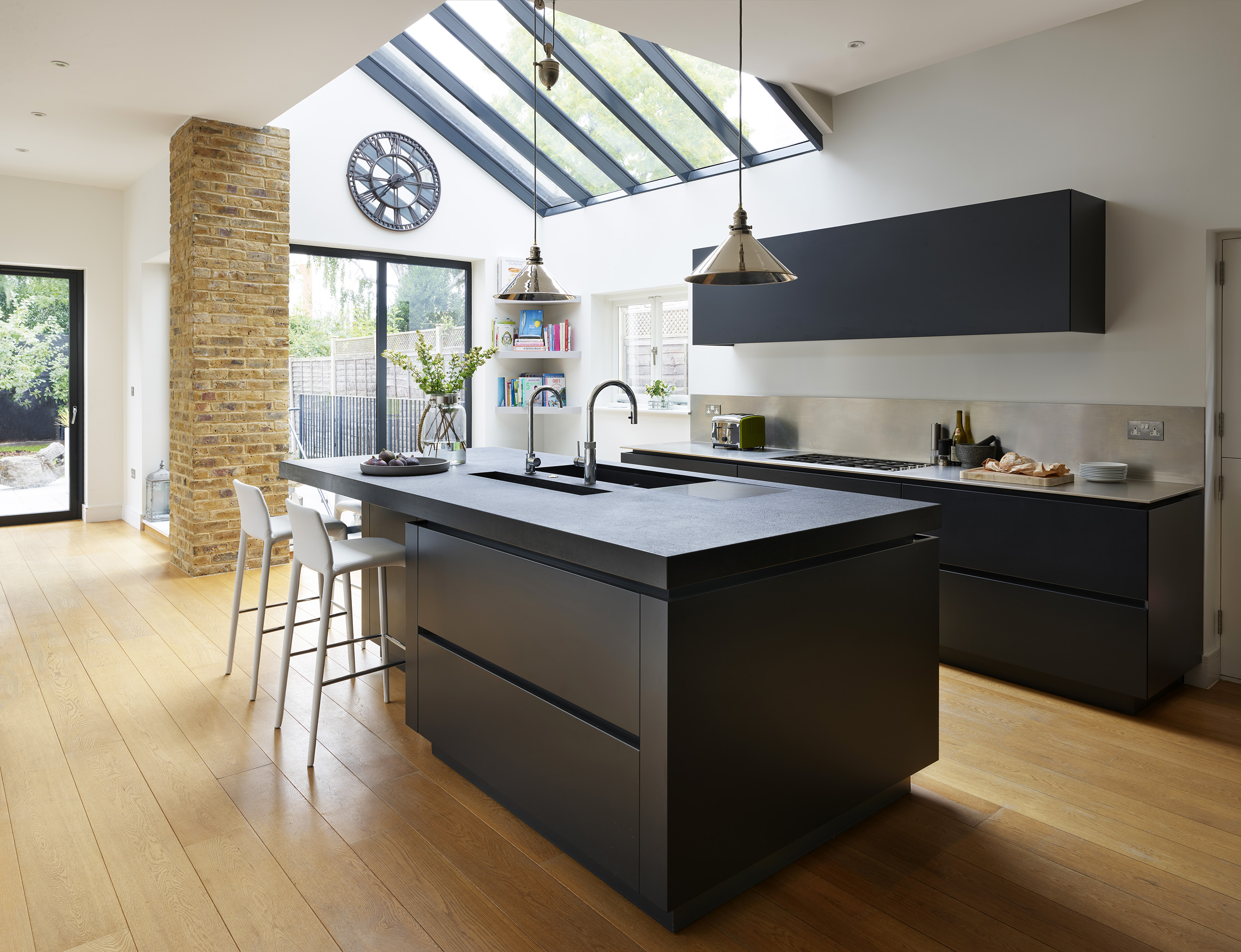Kitchen lighting ideas with black kitchen island and black work surfaces