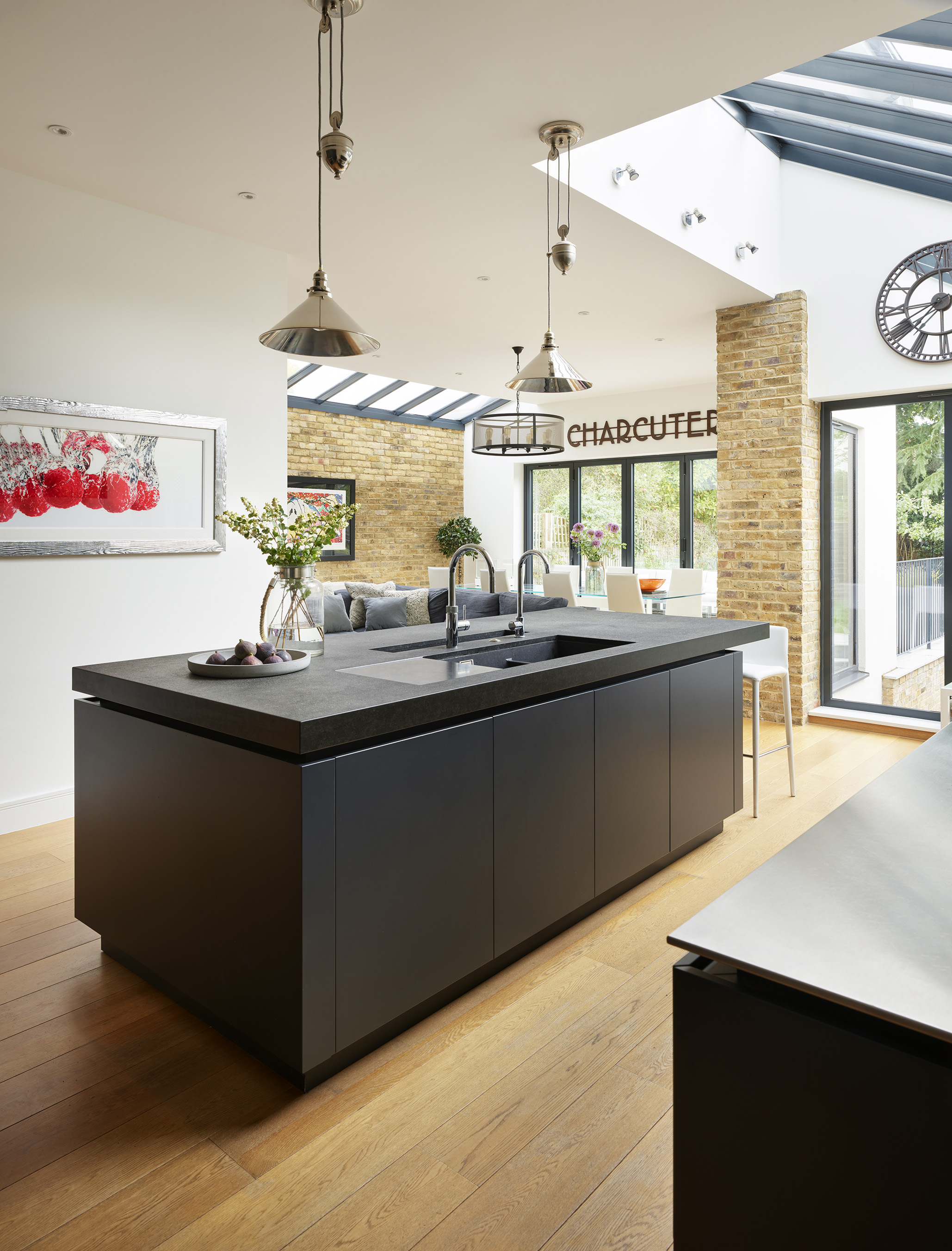 Contemporary kitchen lighting over a kitchen island with black work surface