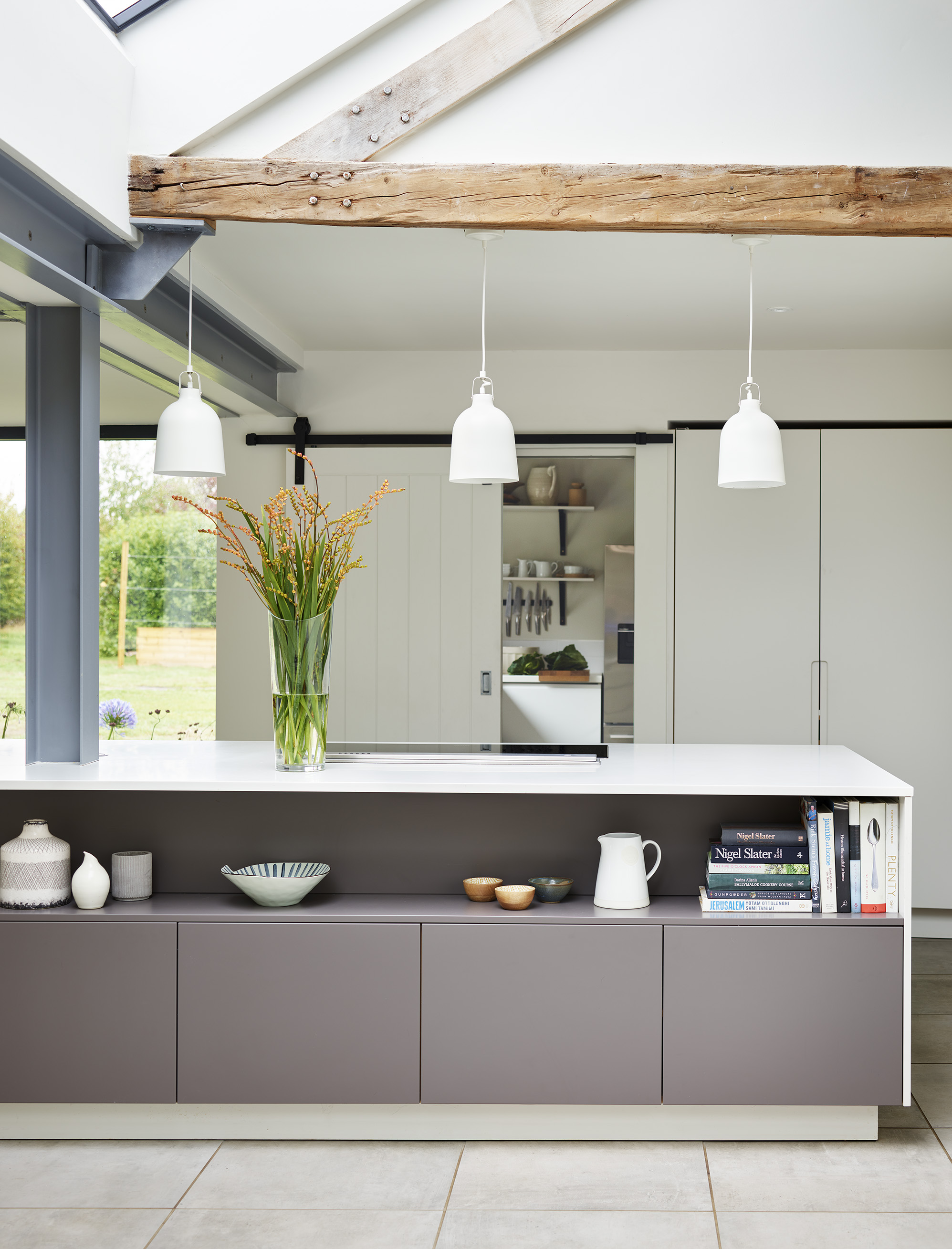 kitchen lighting ideas over a kitchen island with bespoke cabinetry and white work surface