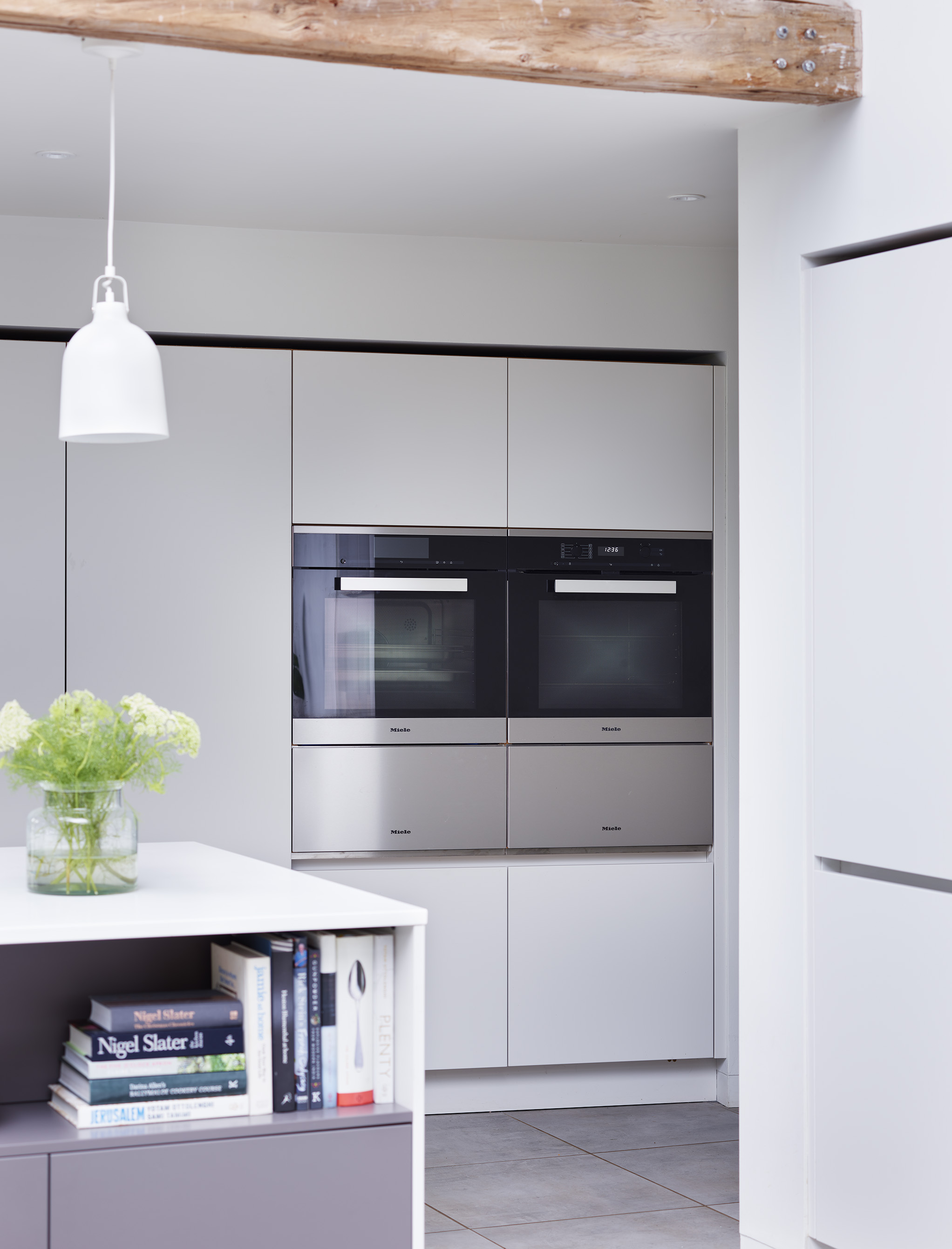 Kitchen showroom in London with kitchen islands by Roundhouse and white bespoke cabinetry