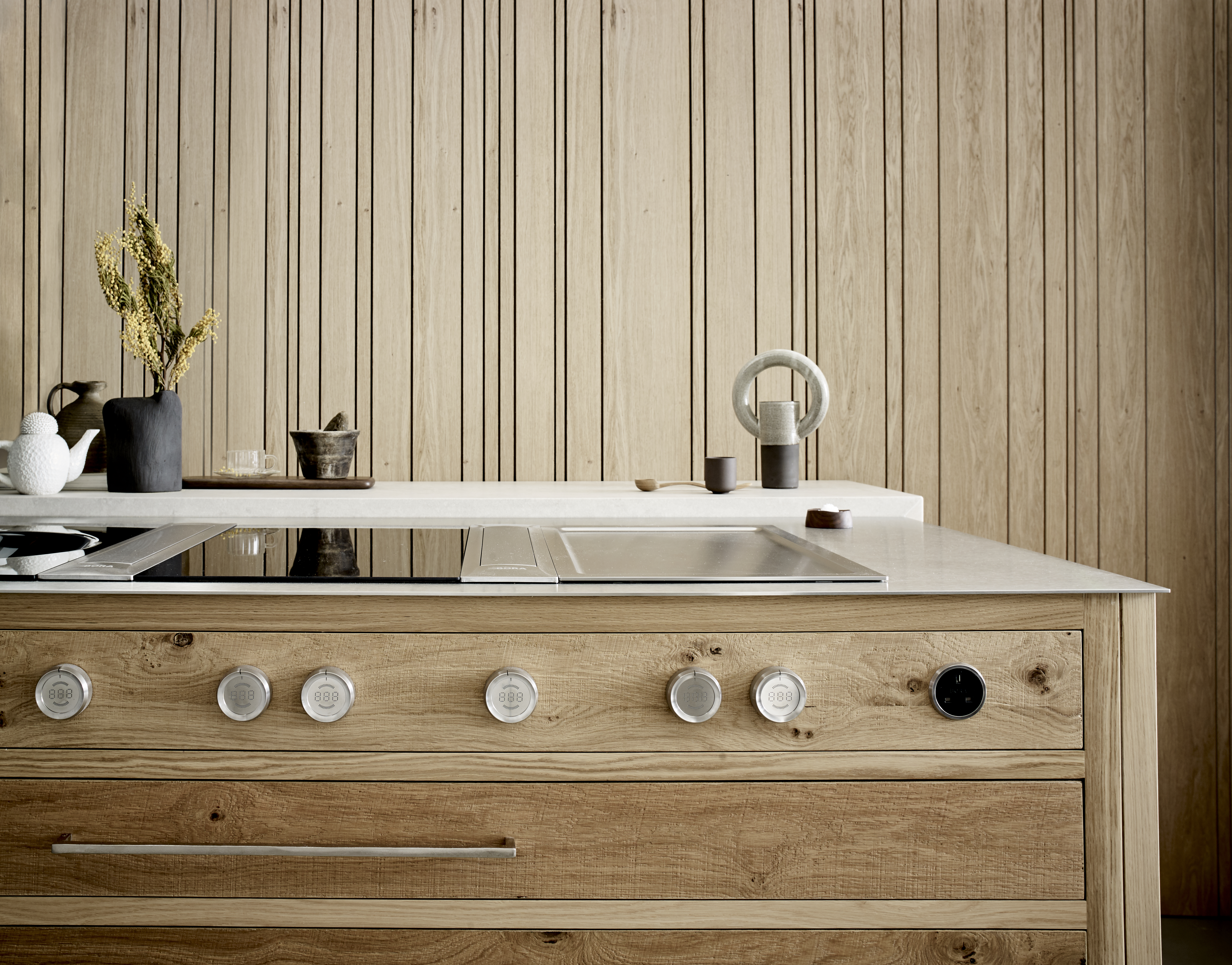 Luxury modern kitchen designs by Roundhouse with kitchen island in oak and stone work surface