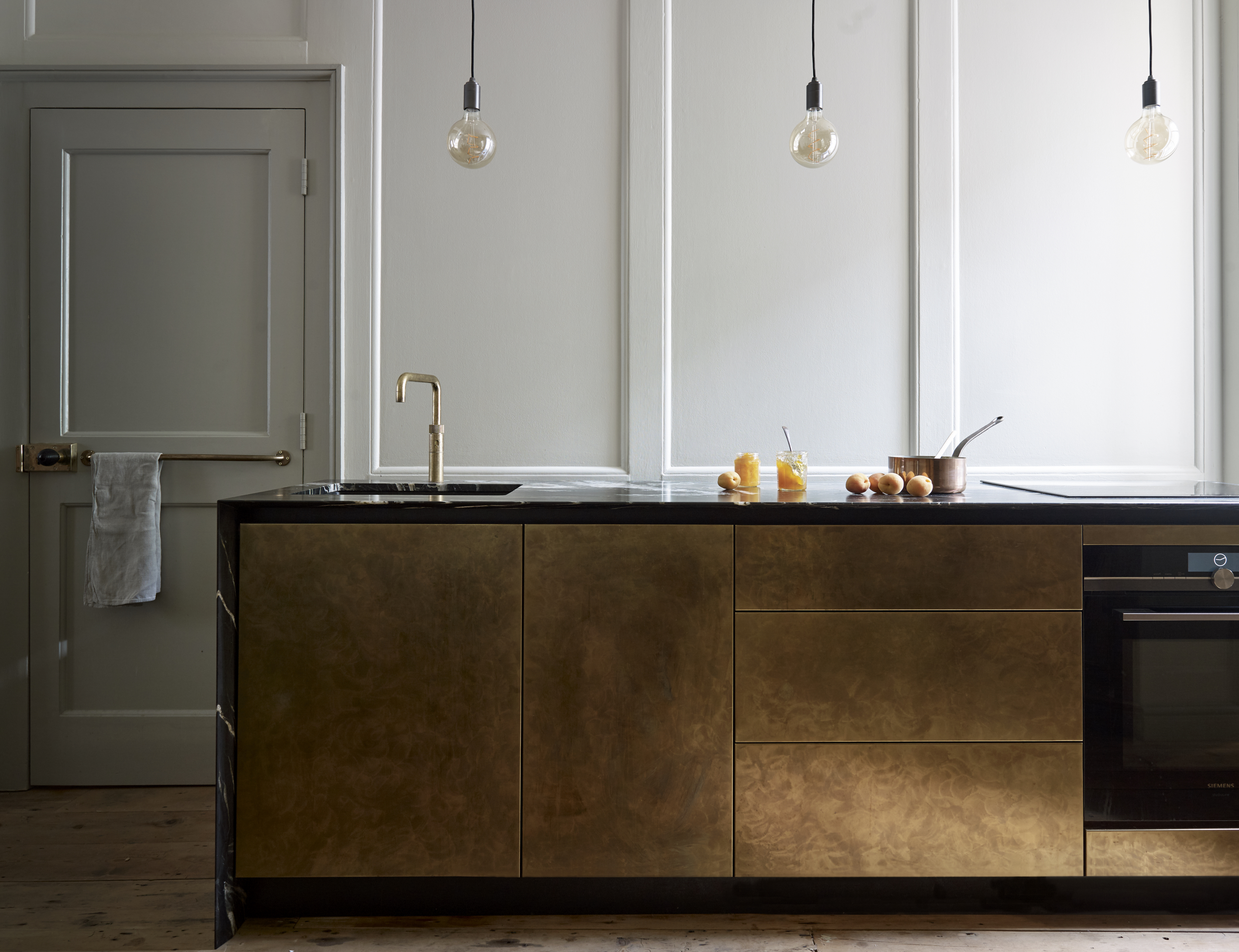 Modern lighting for kitchen with brass island and marble work surface