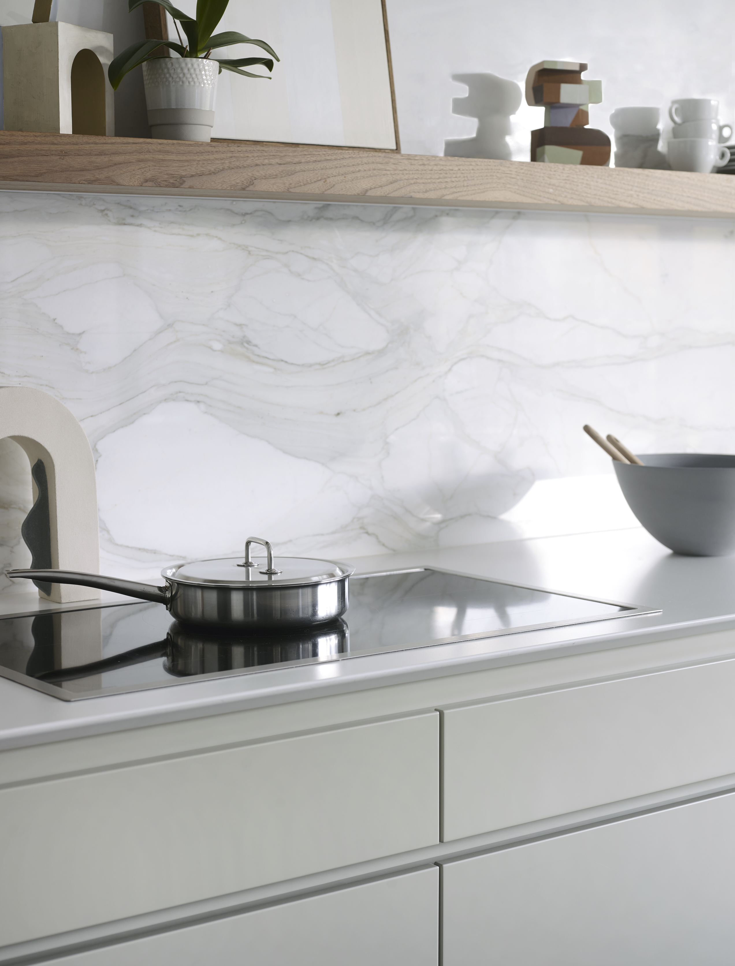 Luxury kitchen appliances with grey bespoke kitchen cabinetry and marble splashback