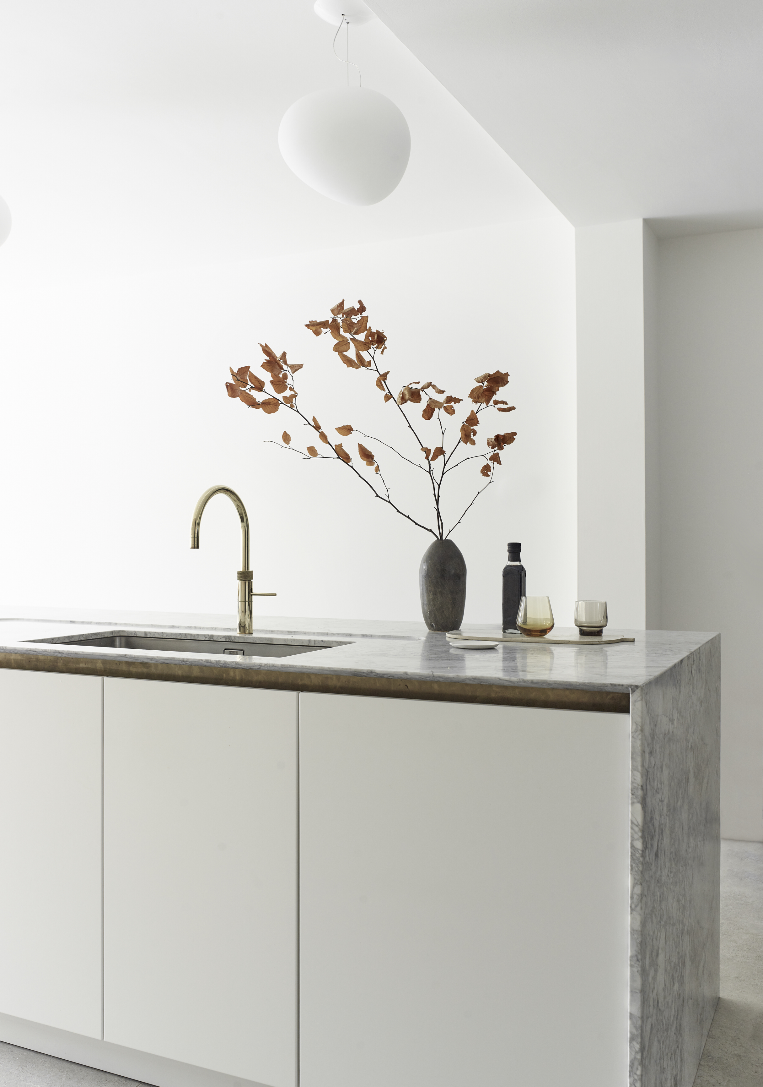 kitchen design luxury by Roundhouse with white kitchen island and marble work surface