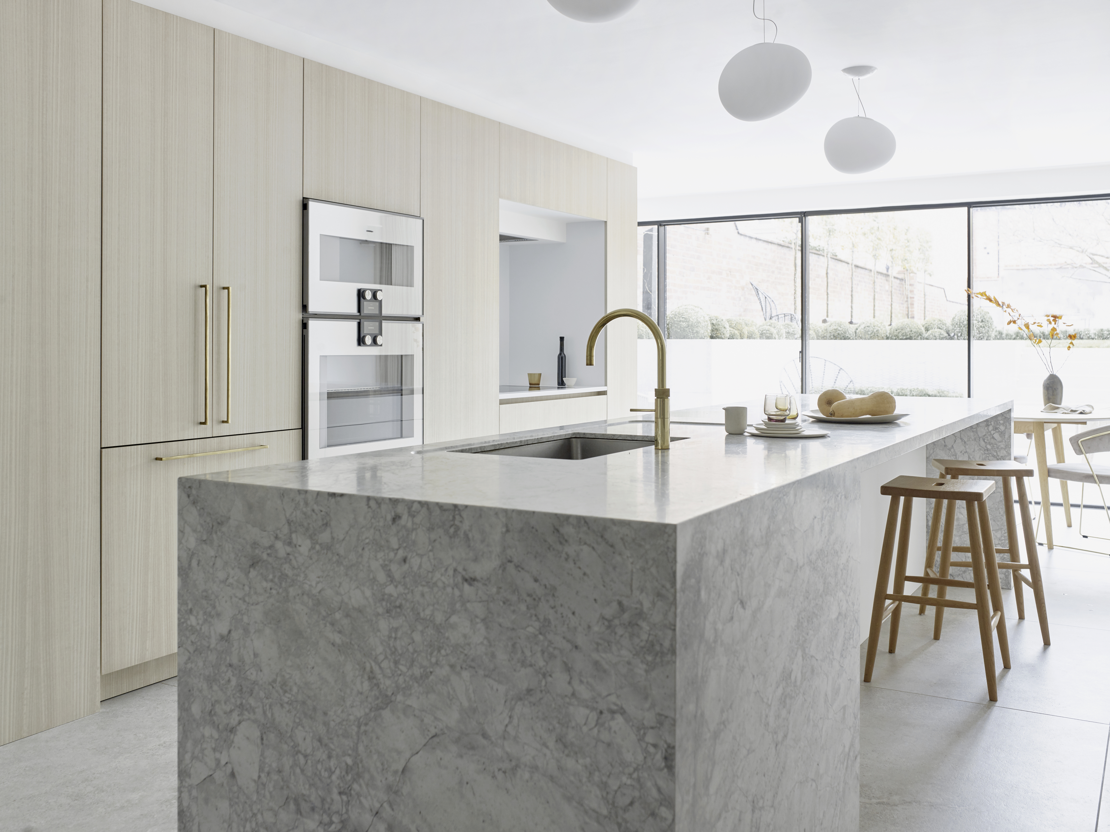 London kitchen design by Roundhouse with marble kitchen island