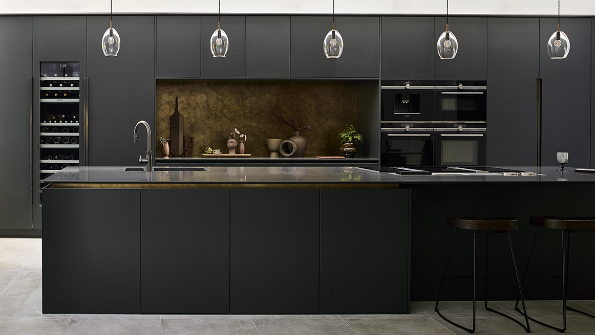 Luxury bespoke kitchen in black with antique brass and dark bronze island