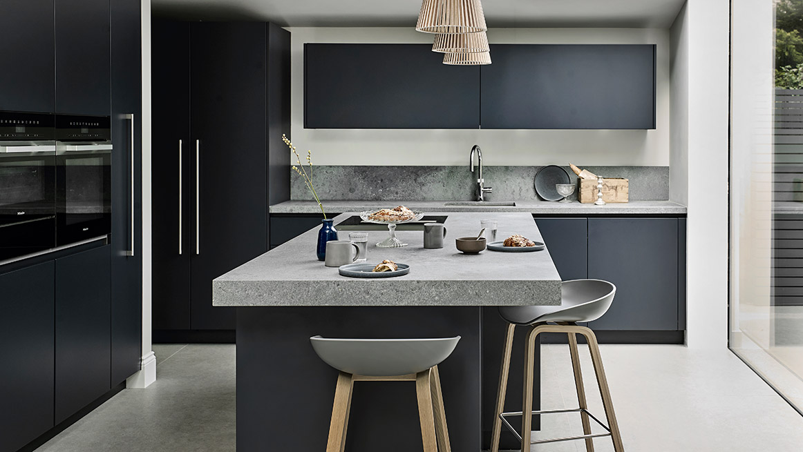 Designer Kitchen with concrete bespoke island and blue matt cabinets
