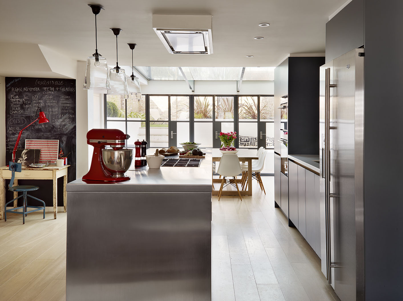 Modern kitchen with island with stainless steel work surfaces