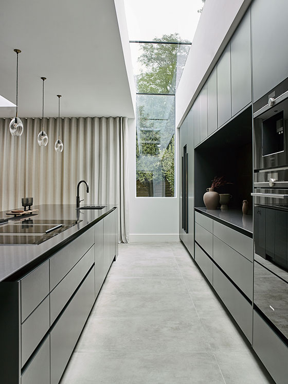 Ideas for modern kitchen by Roundhouse with kitchen islands and black work surfaces