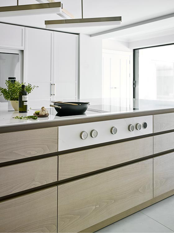 Handle less marble kitchen island with white work surface
