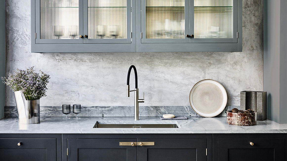 Luxury kitchen design with grey marble worktop and bespoke kitchen glass cabinets
