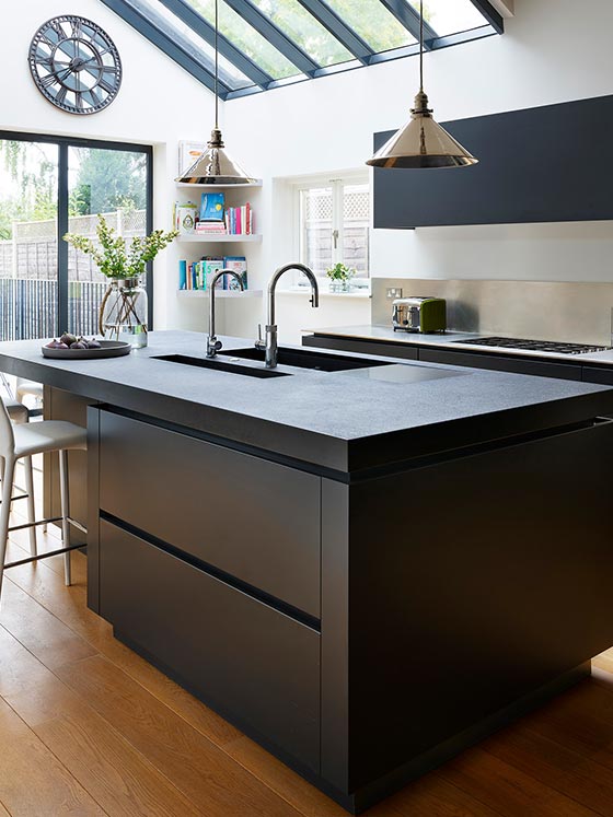 Beautiful kitchen with black cabinetry and work surfaces