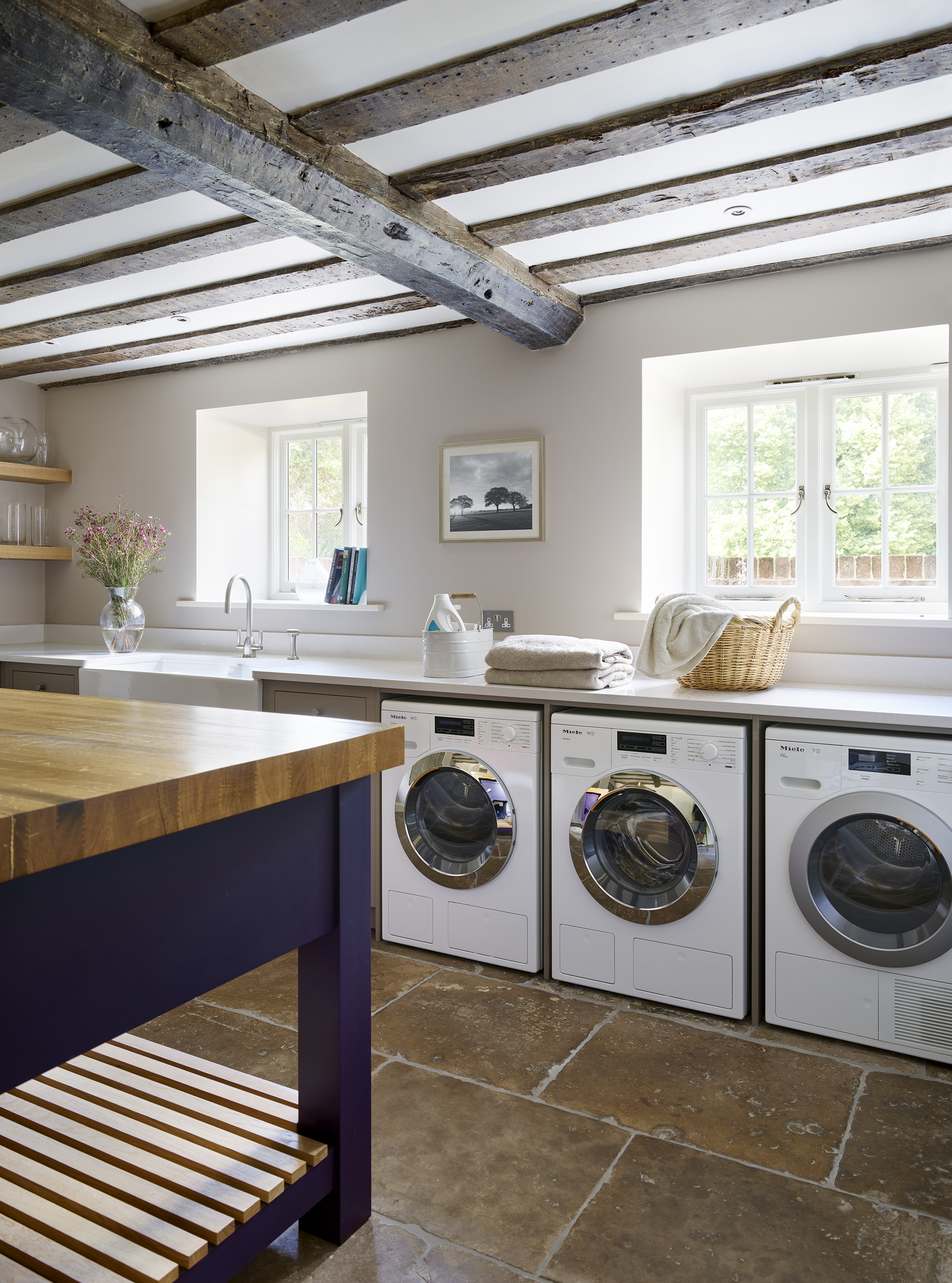 Luxury bespoke utility room with blue and oak island
