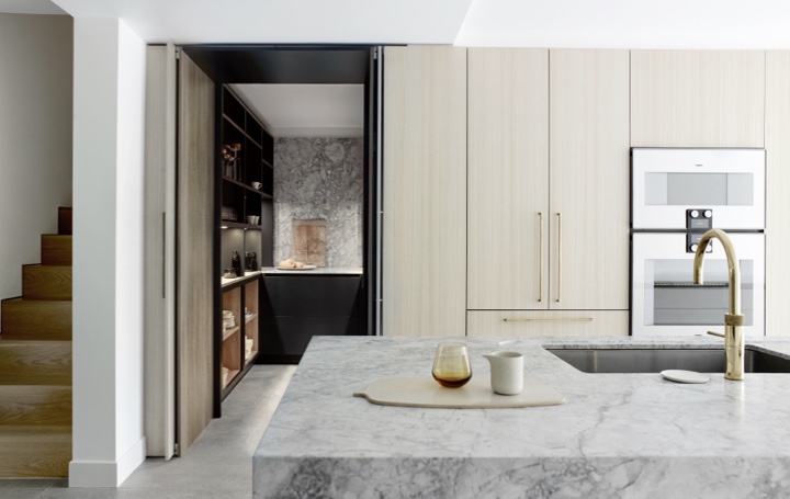 Luxury bespoke kitchen minimal white kitchen with marble worktop and brass tap