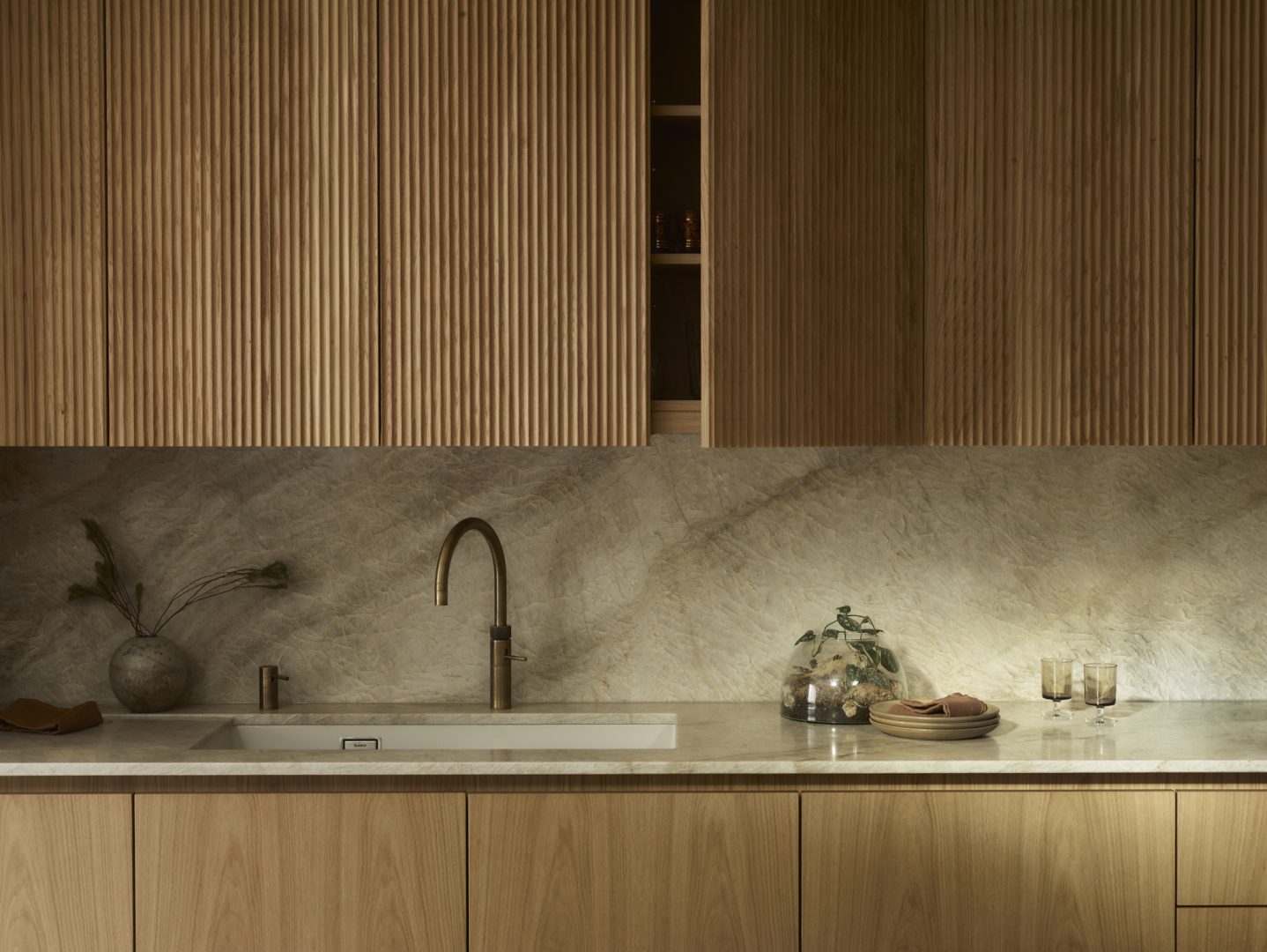 "Working with Professionals" section featuring oak fluted timber cabinetry, brass kitchen tap, marble worktop with ceramic vessel, describing Roundhouse's collaborative approach to transforming designs into bespoke joinery with "CONTACT US" call-to-action