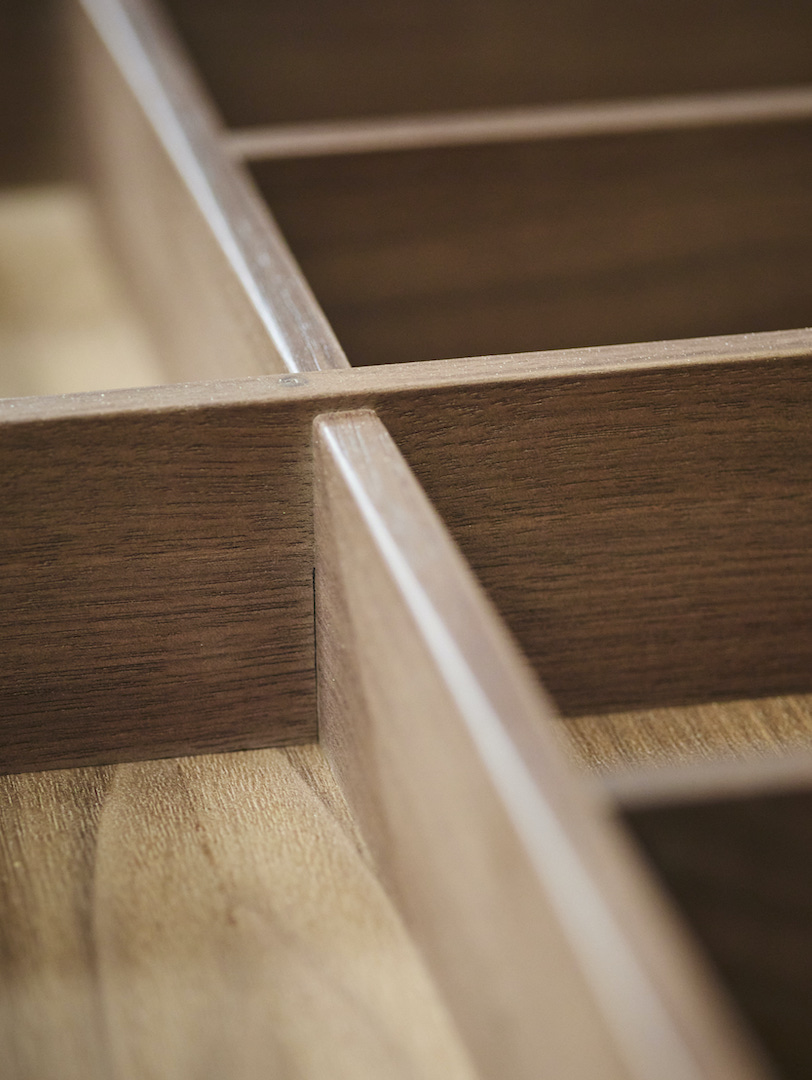 Close-up of precision-crafted timber drawer dividers showcasing bespoke kitchen cabinetry craftsmanship.