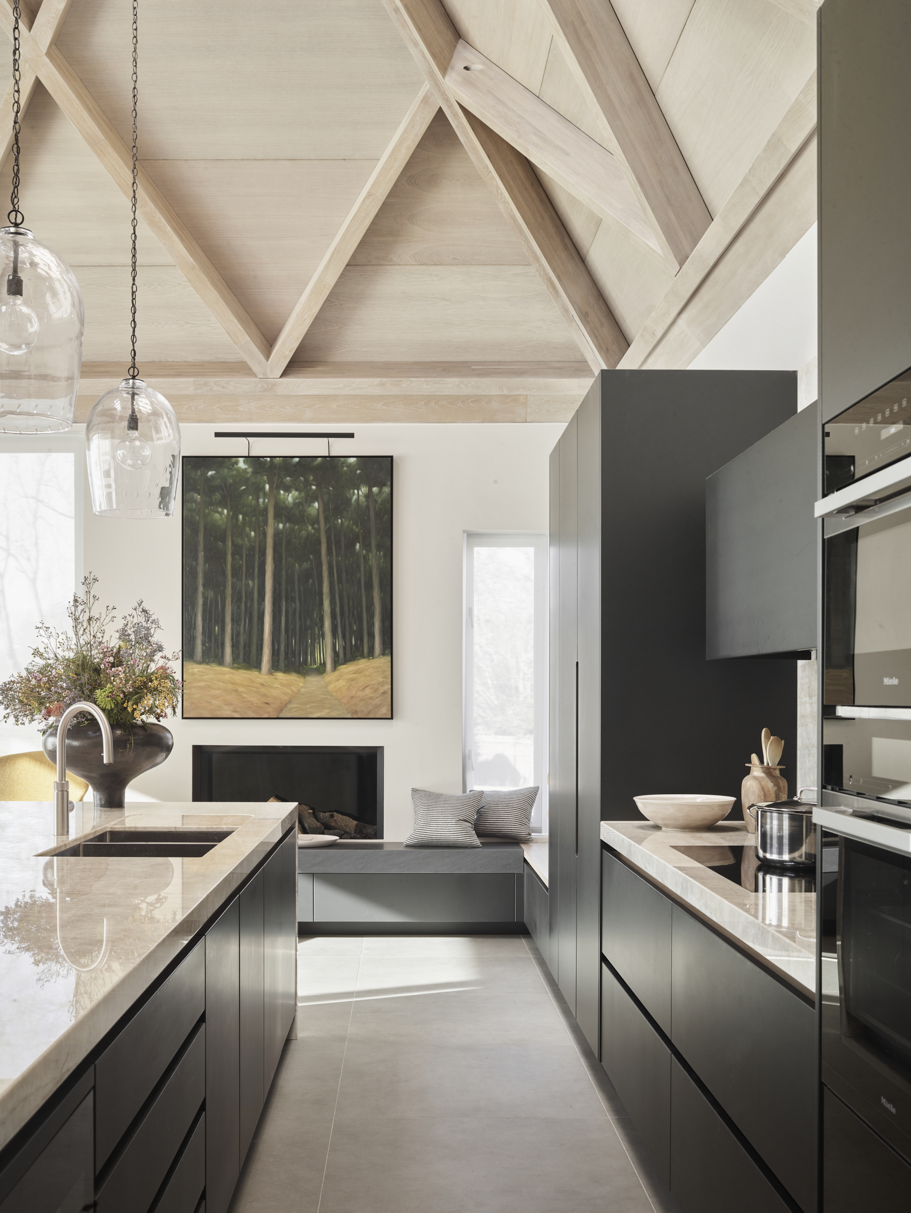 Bespoke soft kitchen featuring a built-in window seat, warm timber ceiling and natural materials, designed to create a calm and welcoming kitchen living space.