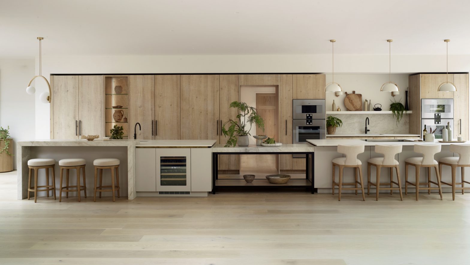 Award-nominated Ashbury bespoke kitchen by Roundhouse Design featuring rough sawn oak cabinetry, white kitchen islands, quartzite worktops and open-plan family living.