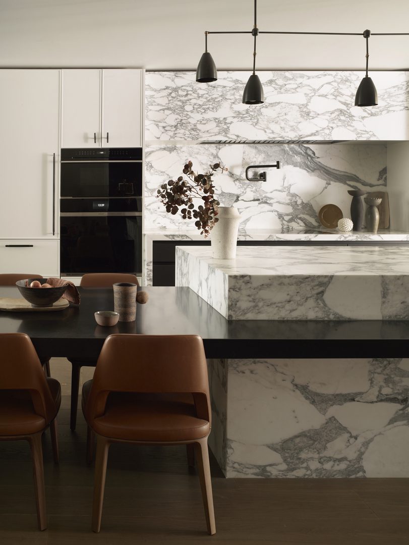 Bespoke white kitchen with dramatically veined marble worktops, splashback and statement island