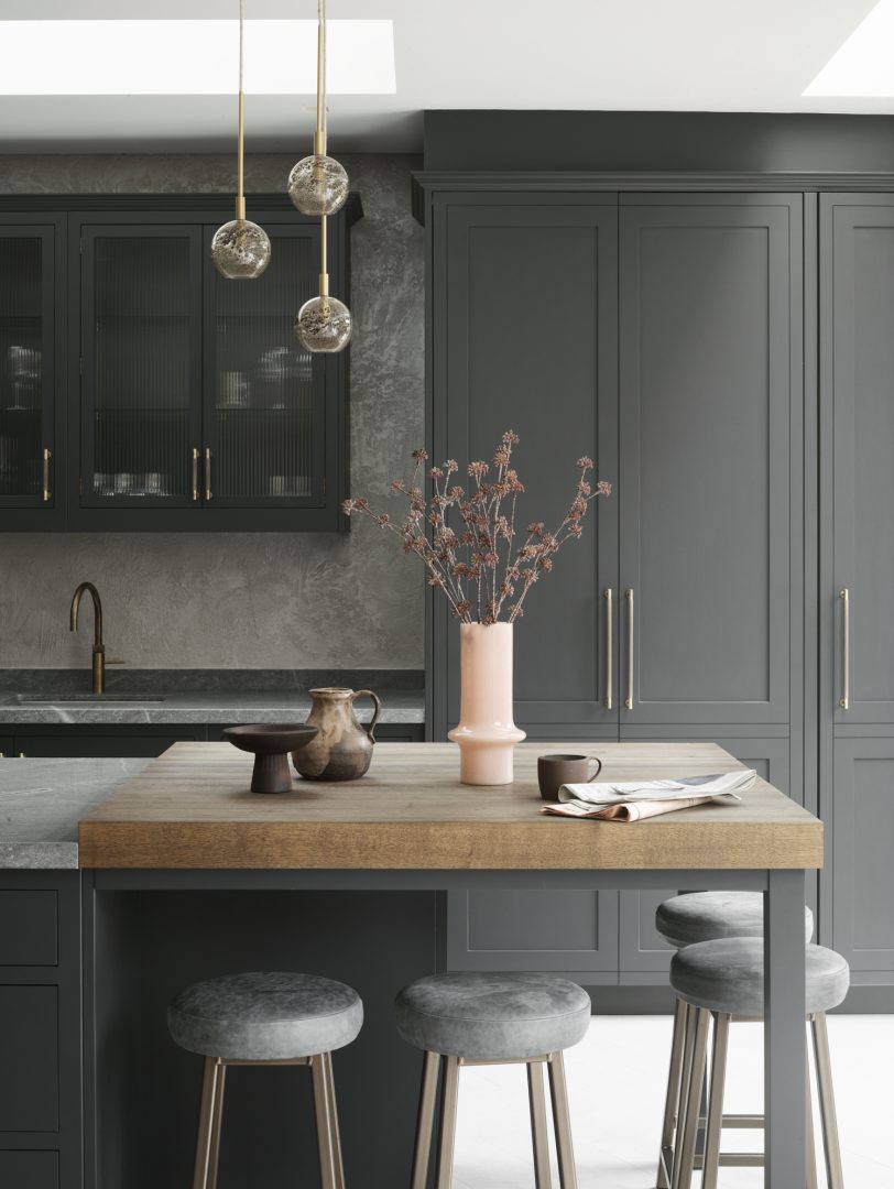 Dark grey Shaker kitchen with a natural timber island worktop and dark stone perimeter worktops