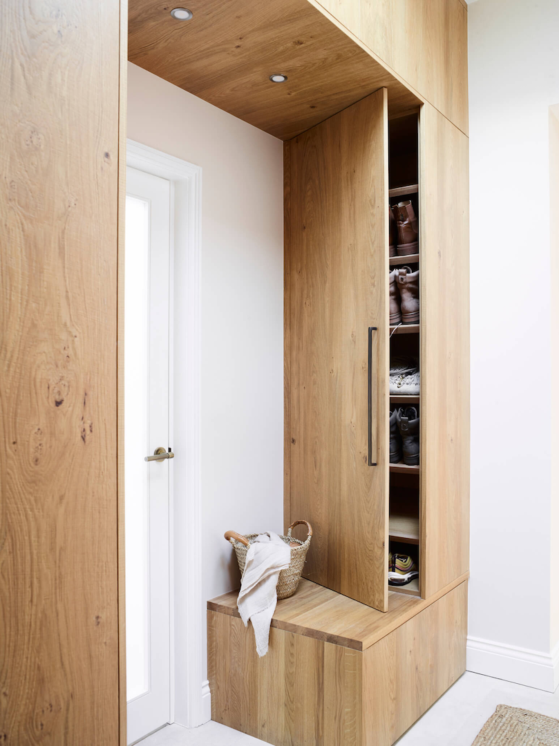 Bespoke oak boot room cabinetry with built-in bench, concealed shoe storage and integrated lighting