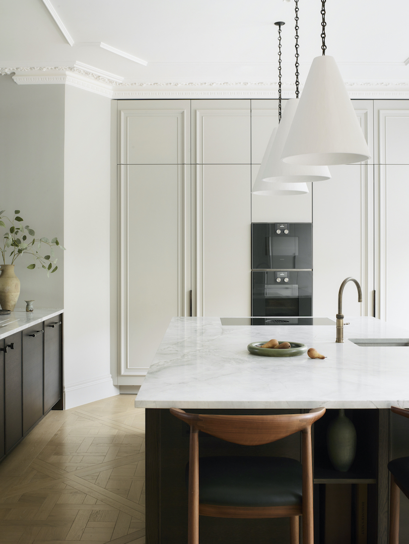 Luxury bespoke kitchen with tailored cabinetry, marble island and architectural detailing in the Roundhouse Meunière project
