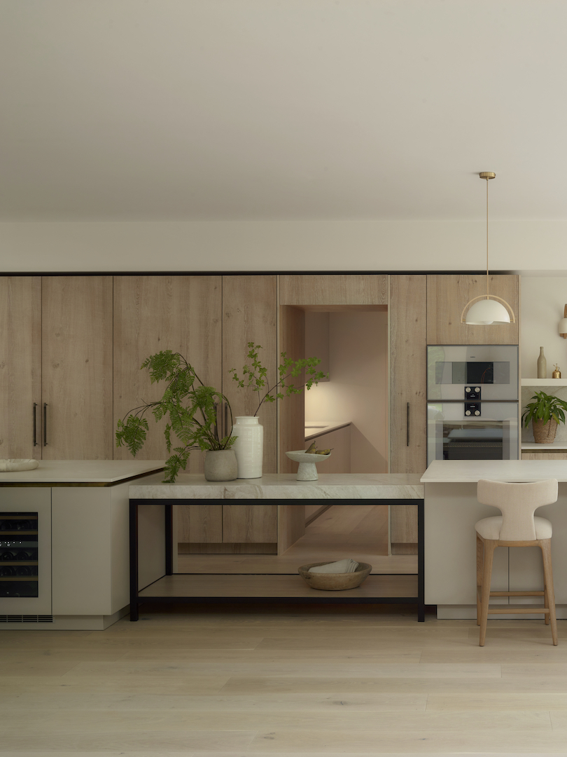 Bespoke luxury kitchen with natural timber cabinetry, stone worktops and a custom steel-framed kitchen island