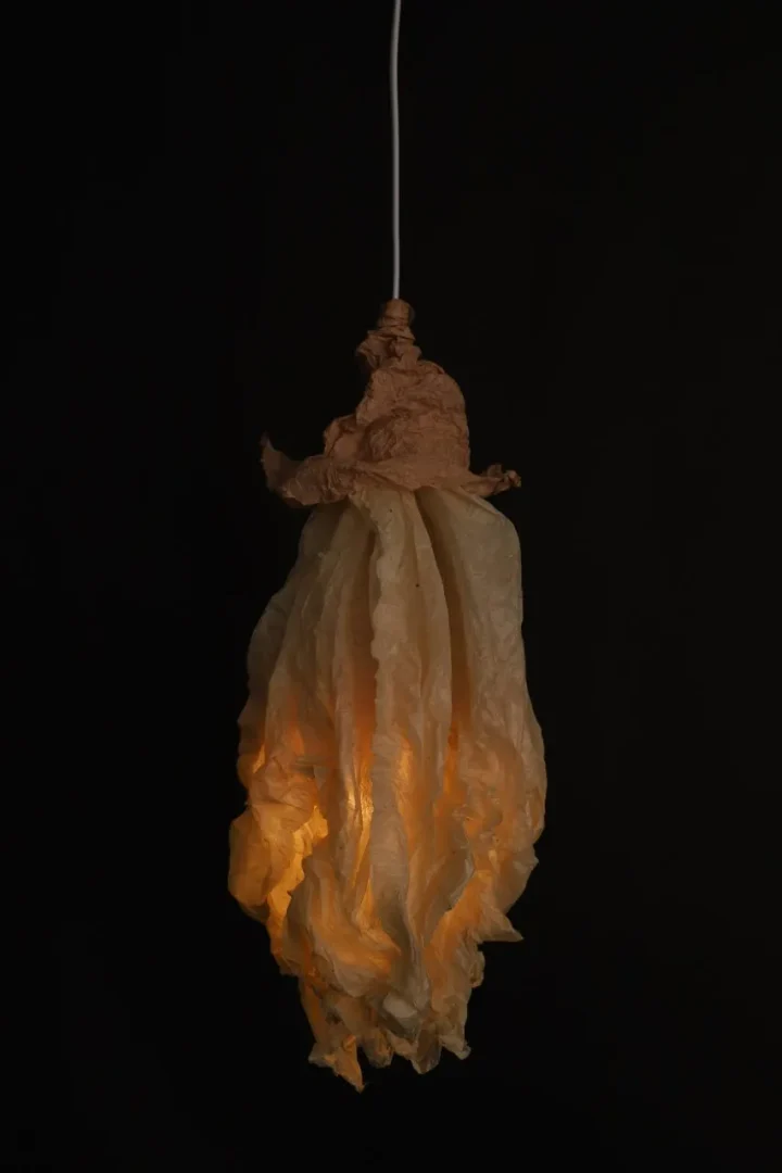 Sculptural, illuminated paper installation suspended against a dark background at Shoreditch Design Week 2026.